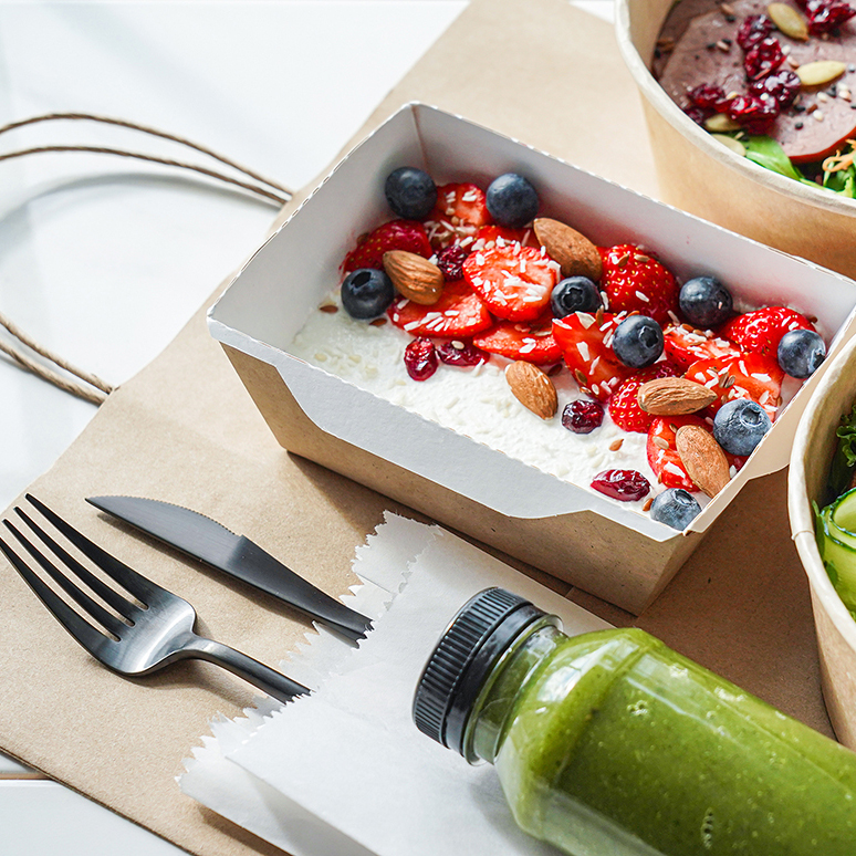 Healthy meal slimming diet plan daily ready menu background, organic fresh dishes and smoothie, fork knife on paper eco bag as food delivery courier service at home in office concept, close up view.